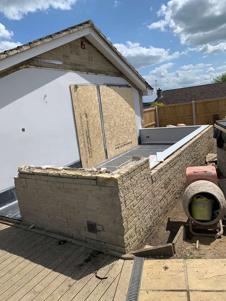 The old conservatory frames removed, leaving the stone dwarf wall and the base