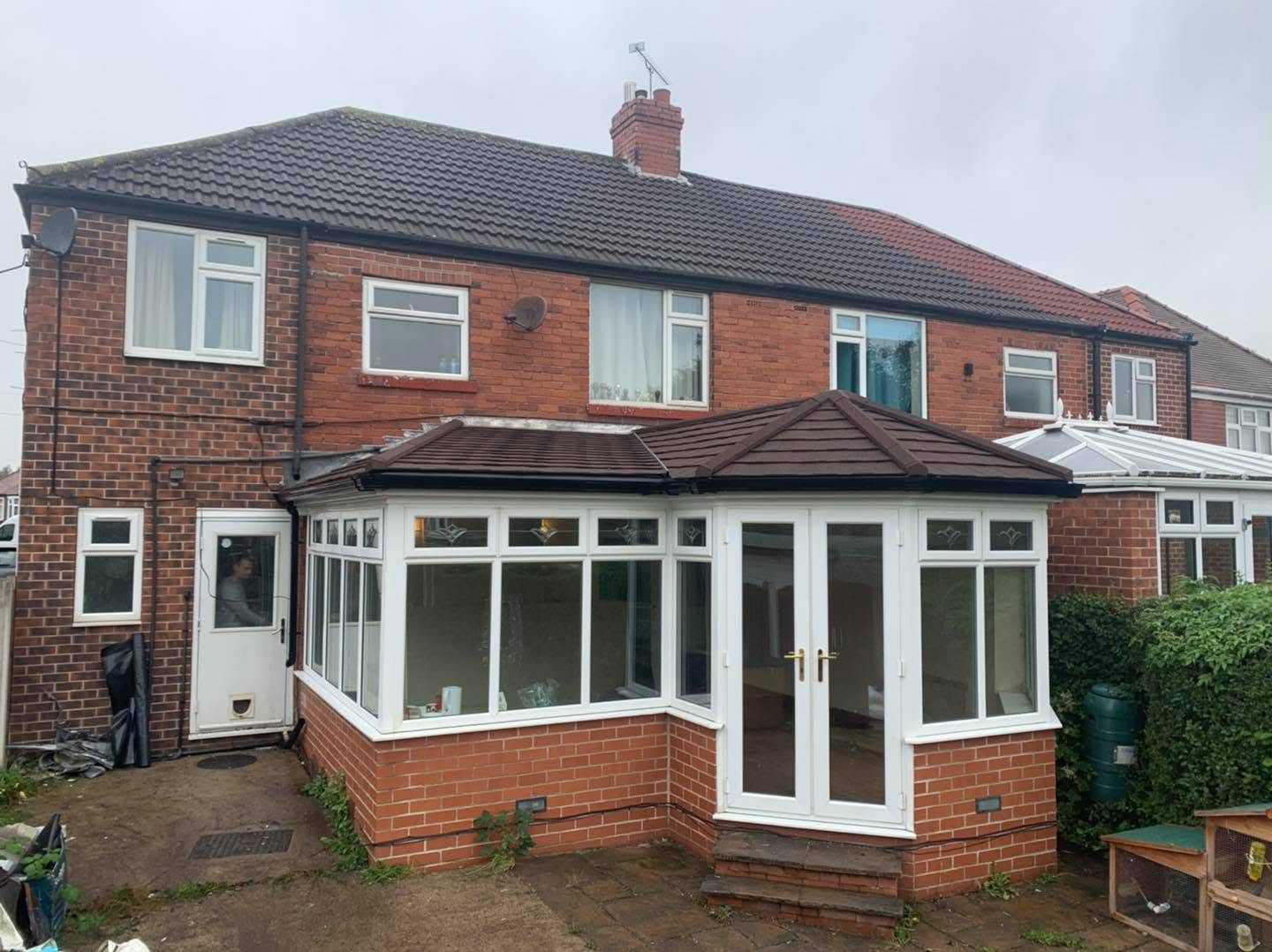 A white framed conservatory with a glazed roof