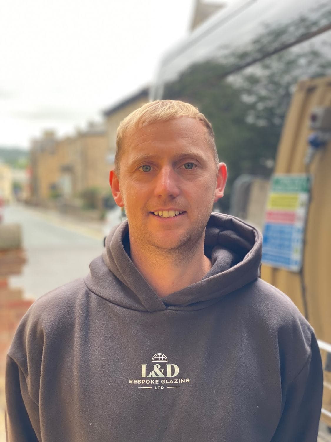Luke Allan of L&D Bespoke Glazing, beside the works van