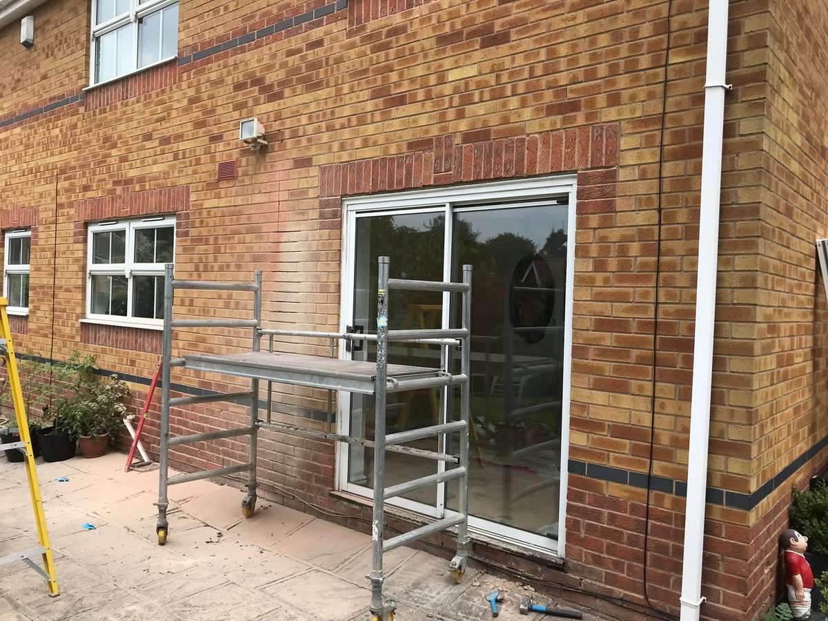 A wide opening being fitted from a scaffold tower