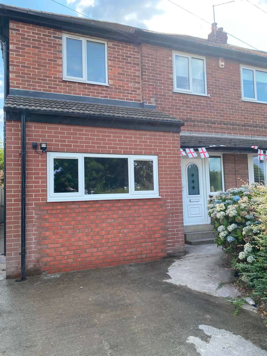 A red brick semi with a full set of new white uPVC windows